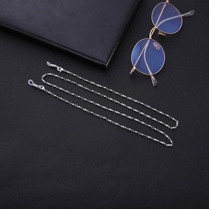 Detail of silver beaded eyewear chain featuring adjustable silicone loops and metal spring