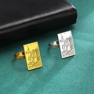 Detail view of gold and silver tarot ring featuring the Six of Swords engraved design