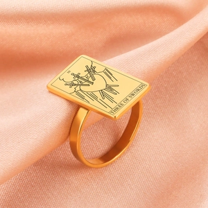 Vintage gold Three of Swords tarot ring in polished stainless steel on silk background