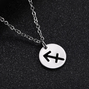 Detailed macro shot of Sagittarius zodiac silver pendant with hollow circular design