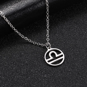 Detail of silver Libra zodiac pendant with hollow circular design on black stone