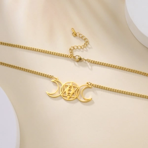 Detail of gold moon phase hexagram necklace with lobster clasp and extension chain