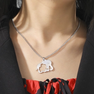 Close-up of a silver stainless steel mother and child elephant pendant necklace on a model