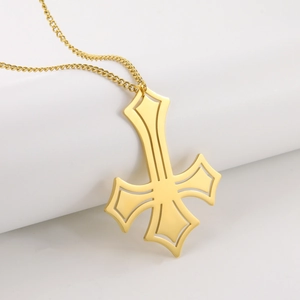 Macro detail of gold plated stainless steel inverted cross pendant with hollow design