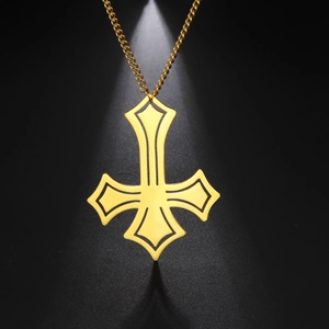 Detail of gold-plated stainless steel inverted cross pendant on a sleek curb chain