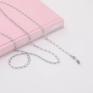 Close-up of silver hollow diamond link eyeglass chain with white silicone anti-slip ends