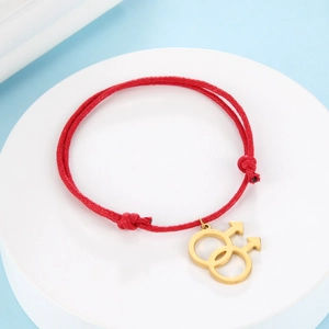 Detail of red braided rope bracelet with golden interlocking male symbols for LGBT pride