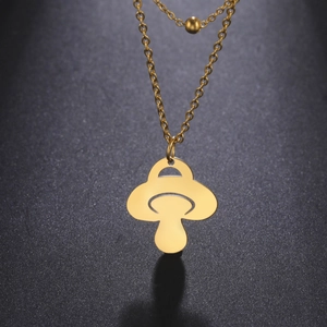 Vue détaillée du pendentif champignon doré ajouré avec chaîne à billes en acier poli