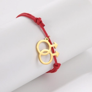 Detail of red braided cord bracelet with interlocking gold male symbols and adjustable knot