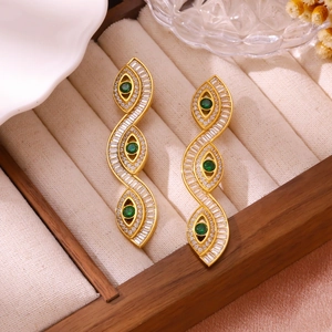 Luxurious gold drop earrings with emerald green stones and pavé set baguette diamonds