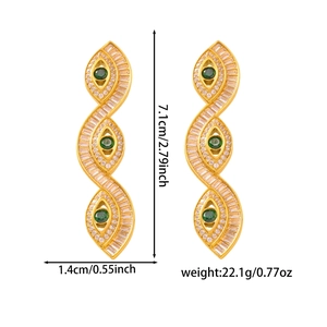 Detailed view of long gold-plated drop earrings featuring green stones and 7.1cm size
