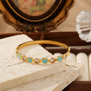 Golden stainless steel bangle with turquoise enamel hearts and round cubic zirconia stones