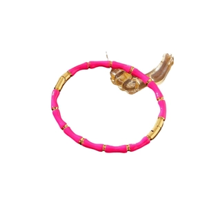 Bamboo-style stainless steel bangle with pink enamel sections and gold-plated finish