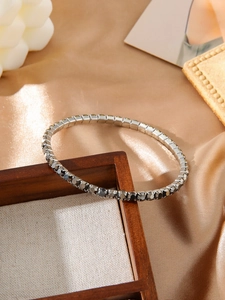 Macro shot of silver elastic titanium bracelet featuring dark grey pavé zircon stones