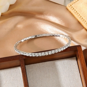 Sparkling silver tennis bracelet with cubic zirconia set on elegant satin fabric background