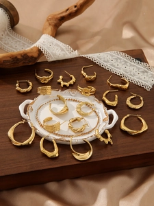 Detailed display of vintage gold-plated titanium earrings with textured hammer finish