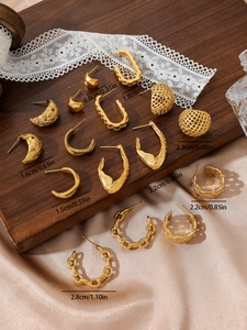 Close-up of gold stainless steel earrings set with chain and woven texture details