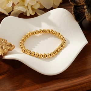 Polished gold beaded elastic bracelet with minimalist round shiny metal beads for women