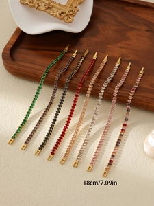 Detail view of 18cm colorful zircon tennis bracelets in 18k gold plating on a wooden tray
