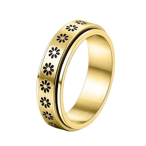 Gold stainless steel fidget spinner ring with black daisy patterns on white background