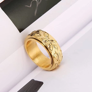 Macro view of gold vintage eye relief ring featuring rotating spinner detail and textures