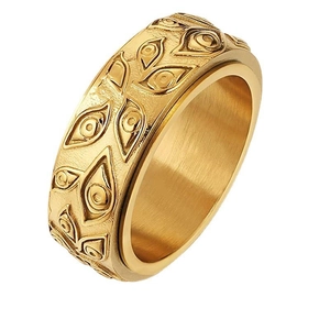 Detail showing the rotating evil eye pattern and brushed metal texture on golden ring