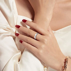 Detail view of silver spinning ring with Roman numerals and crystals on a silk sleeve