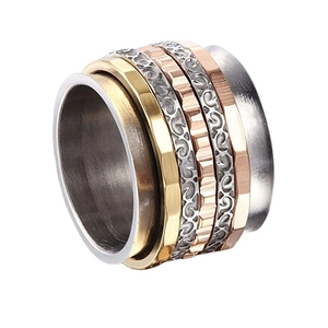 Detailed view of tricolor spinner ring featuring hammered finish and vintage relief patterns