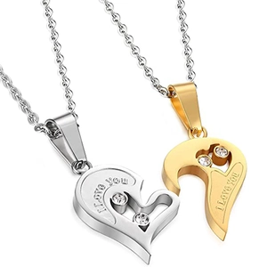 Macro shot of polished heart puzzle pendants with I Love You engraving and tiny crystals