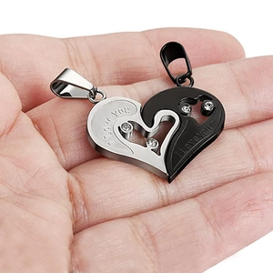 Detailed close-up of interlocking heart puzzle pendants with I love you engraving