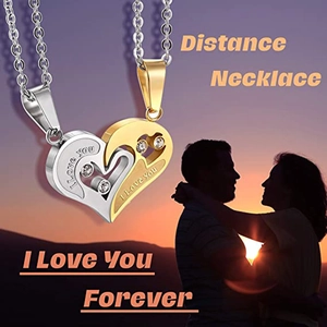 Close-up of interlocking heart pendants in gold and silver with I Love You engraving