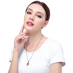 Close-up of heart puzzle pendant necklace in gold and silver on a white t-shirt