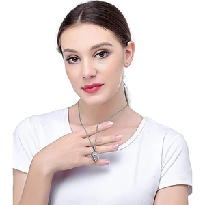 Close-up of interlocking heart pendant with crystals on a delicate silver chain necklace