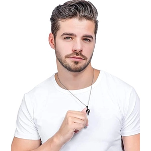 Detail of a minimalist black heart pendant on a thin metal chain worn by a model
