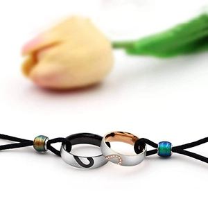 Couples heart pendant necklace set with brushed steel finish and inlaid stones on cord
