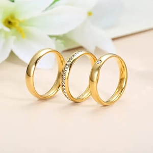Three-piece gold titanium ring set featuring minimalist bands and sparkling zircon inlay