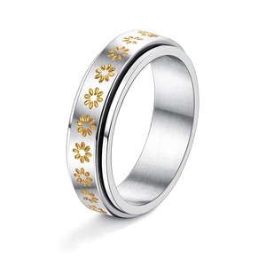 Brushed silver spinner ring with golden daisy pattern for a minimalist aesthetic