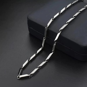 Detail view of silver stainless steel rectangular link chain on a blue jewelry box