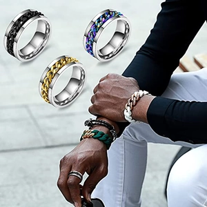 Detail view of rotating Cuban chain rings in black, gold, and rainbow stainless steel