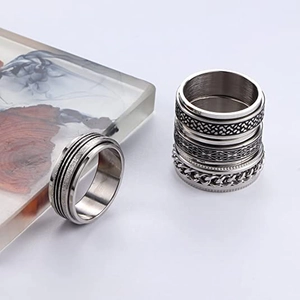 Rotating stainless steel rings with brushed textures and woven chain designs for stress relief