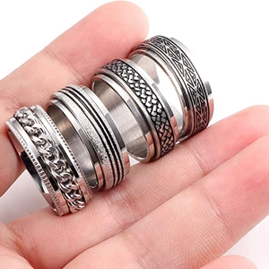 Detail shot of four men's stainless steel rings with rotating chain and matte finish