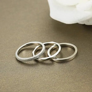 Three-piece stackable 2mm stainless steel rings with frosted, twisted and polished finishes