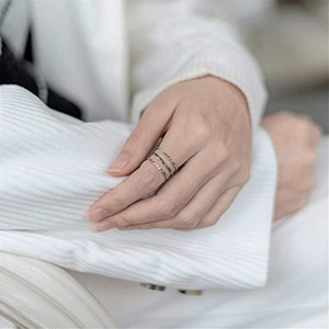 Detail shot of a three-piece set of silver woven rope texture rings on model hand