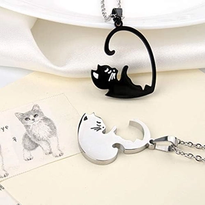 Close-up of black and silver cat couple necklaces showing precise puzzle fit