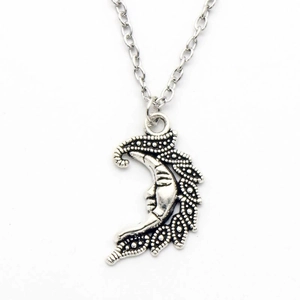 Vintage celestial crescent moon pendant necklace with face detail in antique silver finish