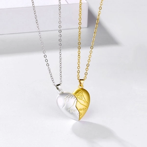 Close-up of magnetic heart-shaped couple necklaces with Forever engraving and pinky swear icon