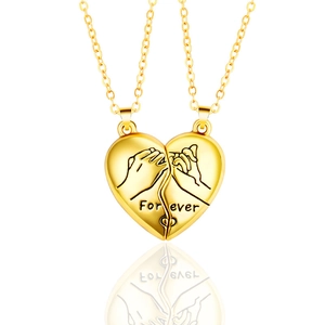 Detail showing magnetic heart pendant with pinky swear illustration and Forever engraving