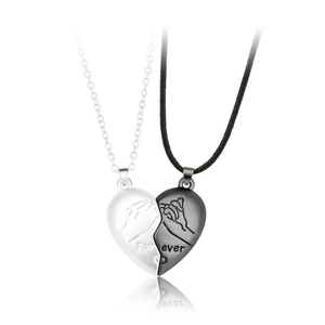 Macro detail of magnetic heart pendants with pinky swear pattern and Forever engraving