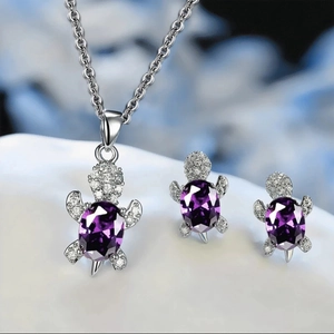 Elegant turtle jewelry set with purple gemstones and white zircons on necklace and earrings