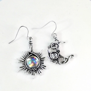 Détail macro de boucles d'oreilles soleil et lune rétro en argent avec pierre de lune